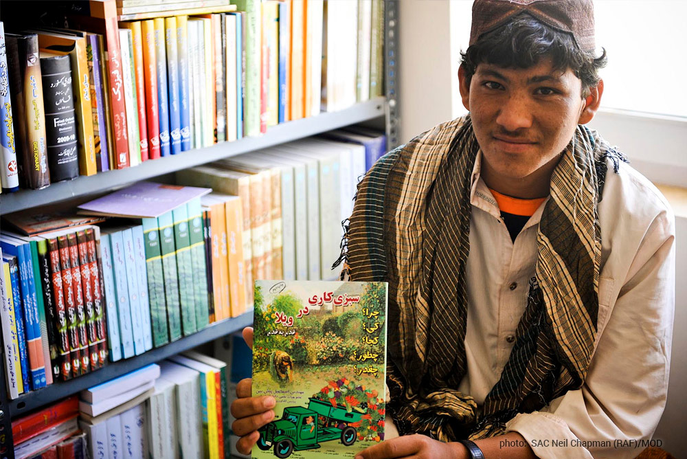 Afghan teen with book on farming