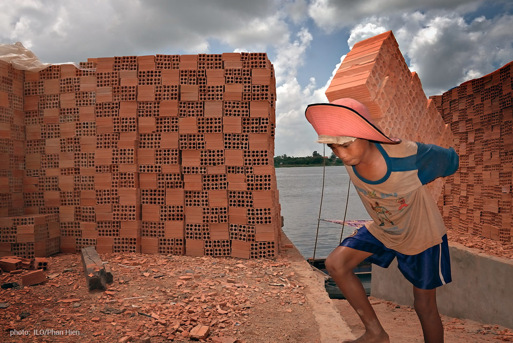 child laborer with bricks